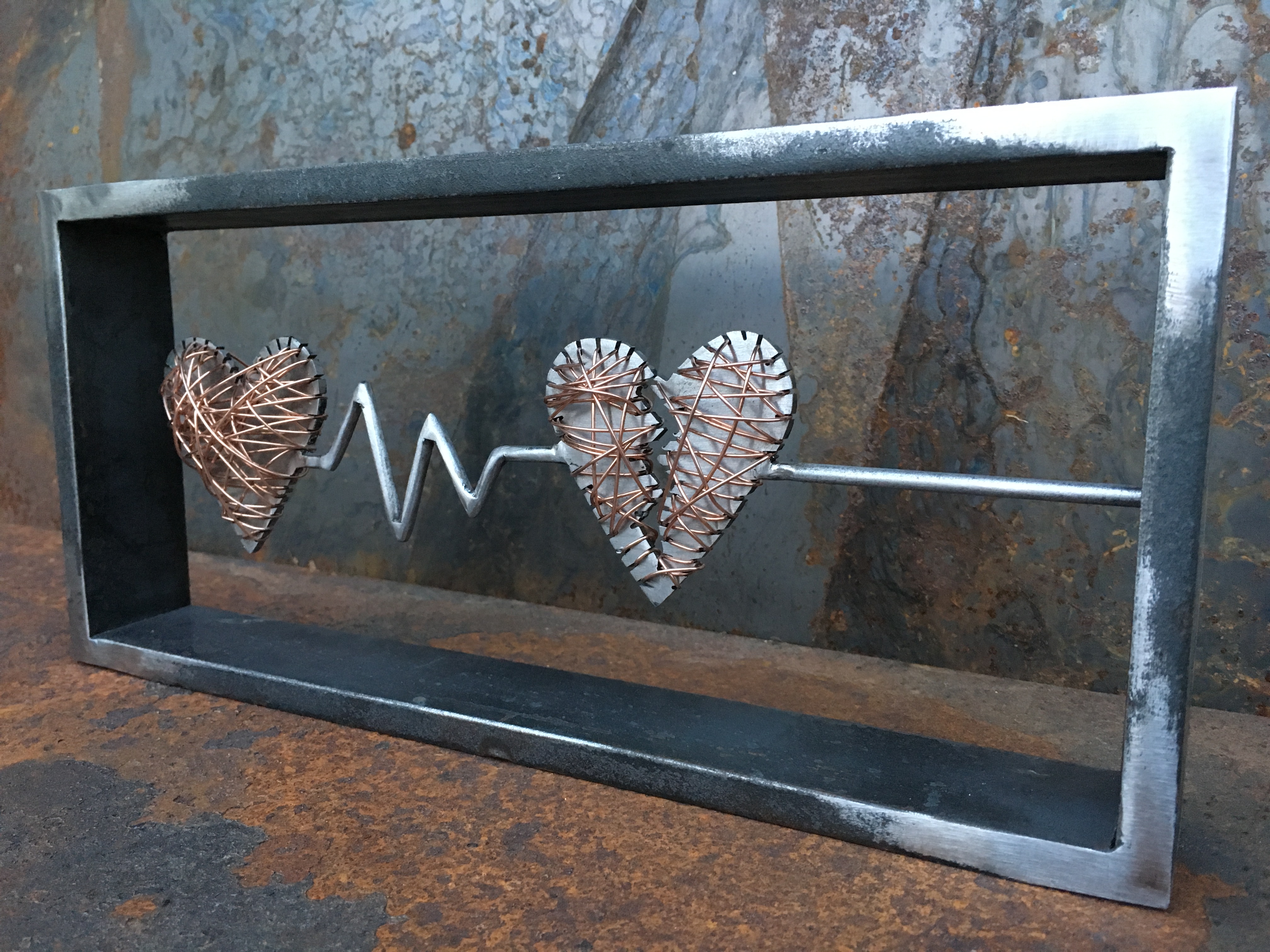 Welding artwork of heartbeat line moving into a flatline